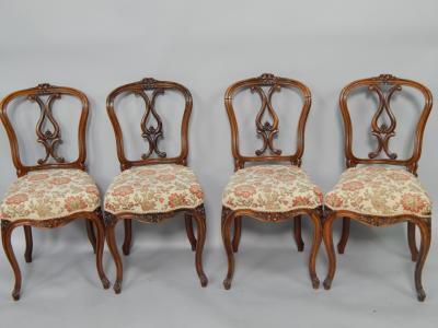 A set of four Victorian rosewood balloon back single dining chairs