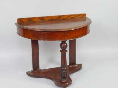 A mahogany and oak side table