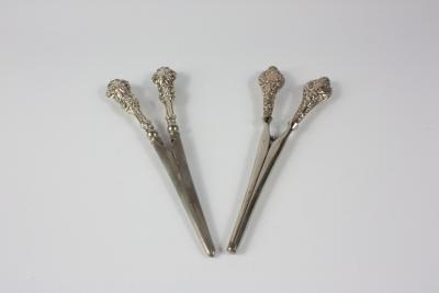 Two pairs of silver handled glove stretchers