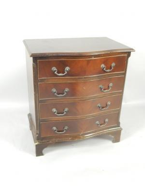A serpentine mahogany chest of drawers