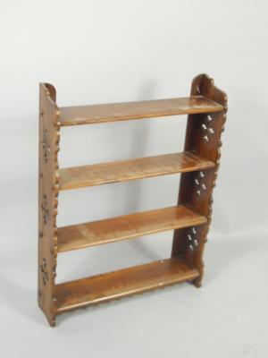 A Victorian walnut wall mounted book rack of four shelves