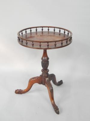 A Georgian style circular mahogany occasional table with a galleried top