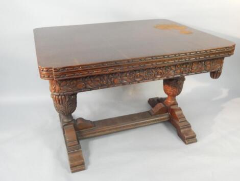 An oak Elizabethan style draw leaf dining table