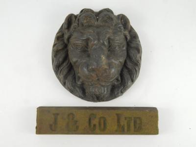 A cast iron lion's head wall plaque