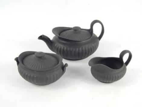 A Wedgwood black basalt mid 19thC three piece tea set