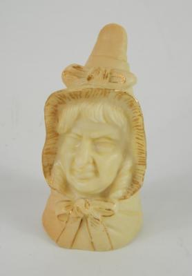 A Royal Worcester porcelain candle snuffer modelled as Mrs Caudle