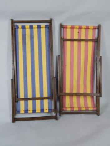 Two mid 20thC oak and striped fabric deck chairs.