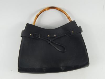 A lady's black leather handbag with bamboo handle