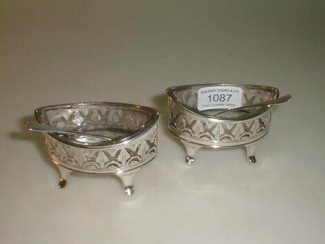 A pair of George III silver oval salts with pierced anthemion borders