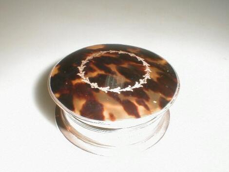 A George V circular silver trinket box with tortoiseshell effect cover