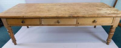 A large 19thC pine kitchen table