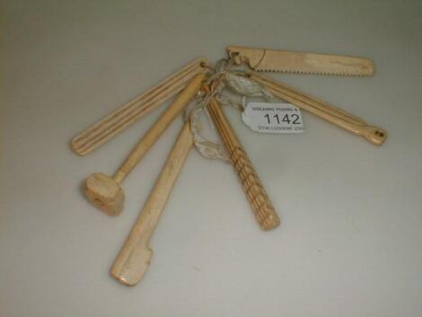 A group of 6 carved bone ships carpenters tools formed as a baby's rattle/teething pieces