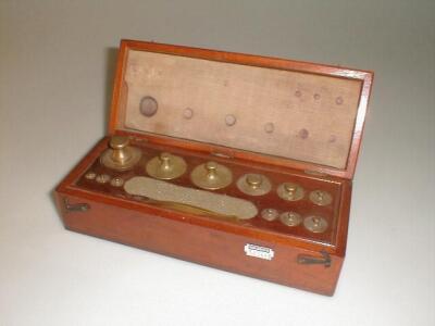 A mahogany cased set of chemical balance weights