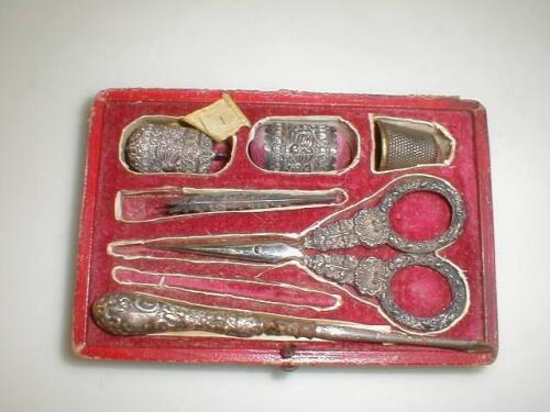 A leather cased sewing set