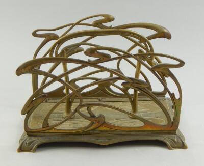 An Art Nouveau brass two division letter rack