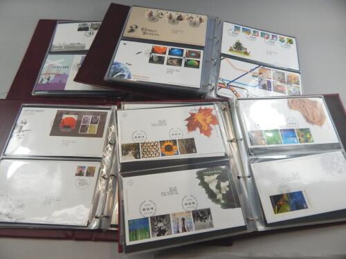 A large quantity of first day covers in four albums