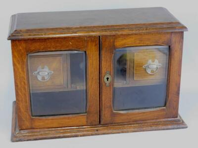 An Edwardian oak smoker's cabinet