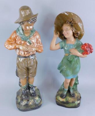 A pair of early 20thC painted plaster figures