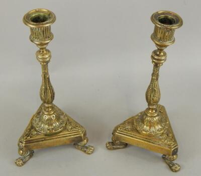 A pair of mid 19thC Empire style brass candlesticks