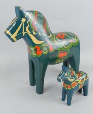 A Nils Olsson Swedish folk art painted horse and another