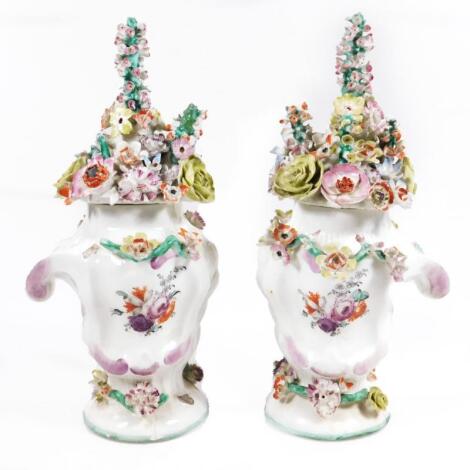 A pair of Longton Hall rococo moulded vases with covers