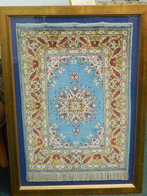 A framed Turkish small rug or mat