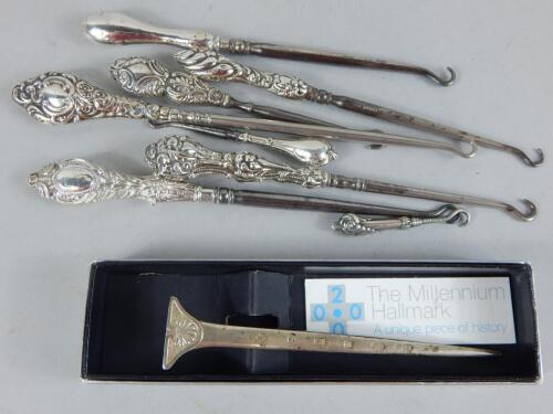 A collection of silver mounted button hooks