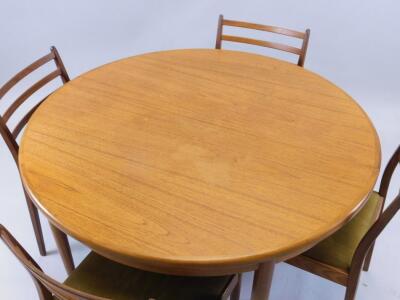 A 'G' plan teak retro extending dining table and four chairs. - 2