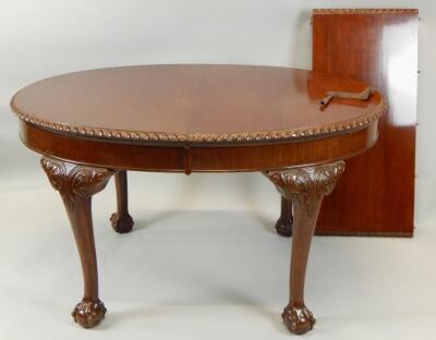 A mahogany extending dining table