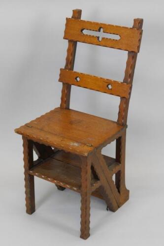 A Victorian carved oak Gothic style metamorphic library chair