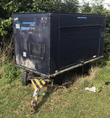 A blue twin axle box trailer.