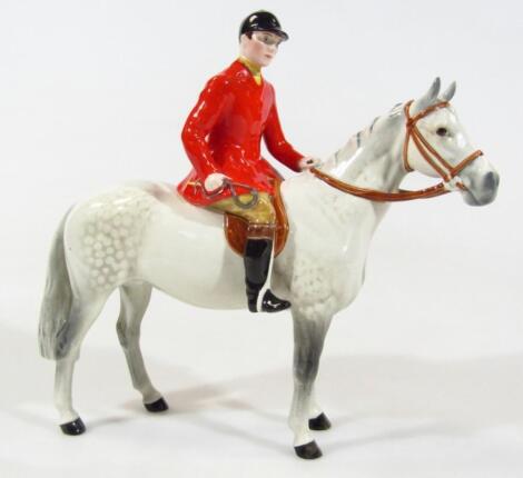 A Beswick red jacketed huntsman on dapple grey horse