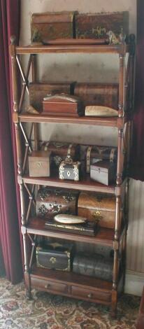 A Regency style mahogany open bookcase with "x" frame end supports