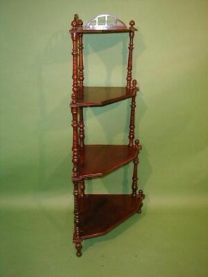 A Victorian walnut corner whatnot with 4 graduated and moulded canted shelves