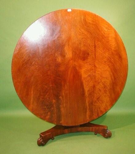 A Victorian flamed mahogany breakfast table with circular tilt top