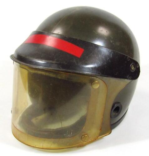 A green plastic riot helmet