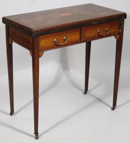 An Edwardian mahogany fold over tea table