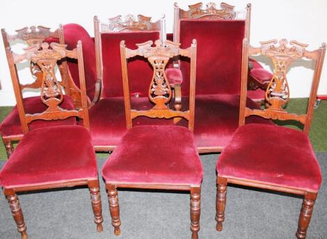 A late Victorian walnut framed salon suite