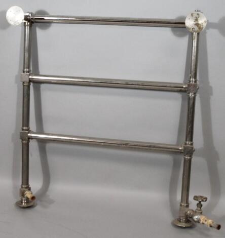 A chrome plated wall hanging towel rail