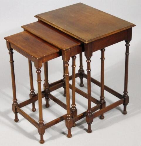 A nest of three Edwardian mahogany tables