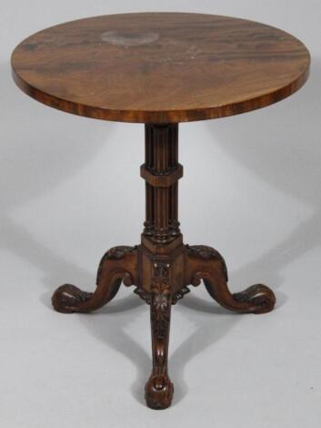 A heavily carved walnut occasional table