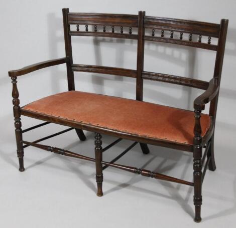 An Edwardian stained wooden framed double settee