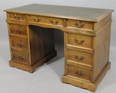 A 20thC walnut twin pedestal writing desk