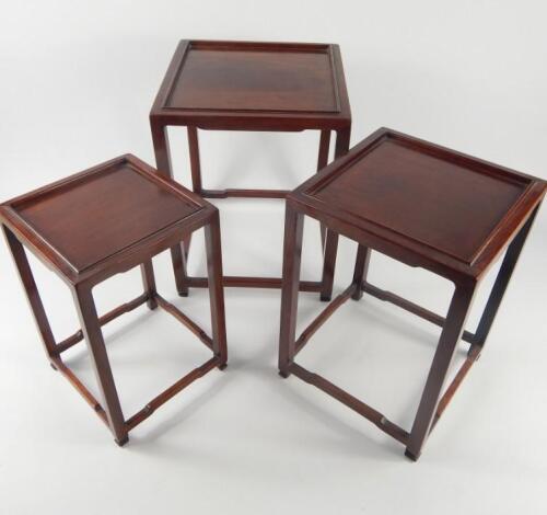 A set of three graduated Chinese rosewood jardiniere stands