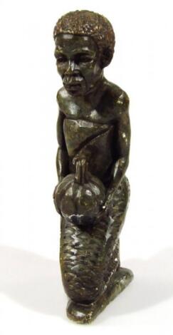 A heavily carved African tribal stone figure of a lady