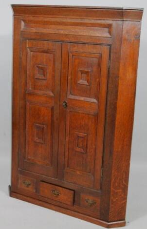 An 18th oak hanging corner cupboard