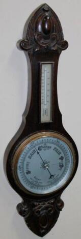 An early 20thC oak stained banjo barometer and thermometer