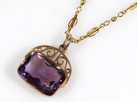 A 9ct gold fob set with amethyst coloured fixed charm