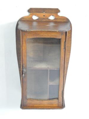 An Art Nouveau oak mounted smoker's cabinet