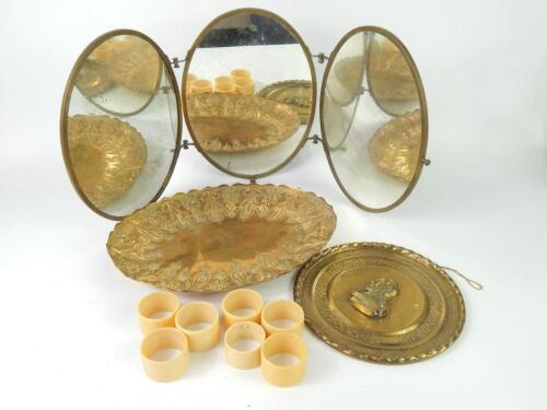 An oval brass framed triptych dressing table mirror